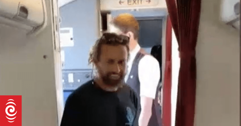 TV personality Andre Rerekura captures snake on the plane