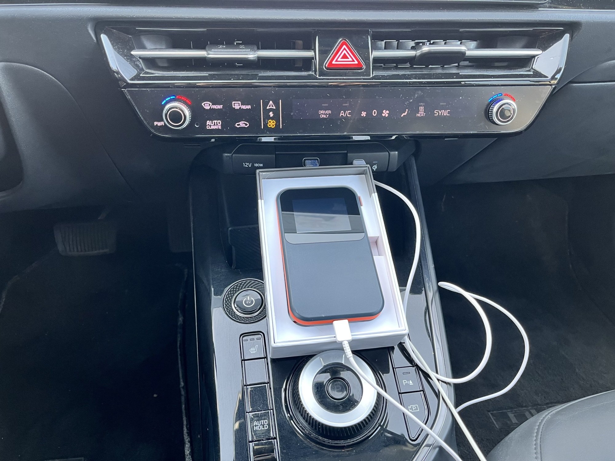 A Solis Edge pocket wifi resting on the center console in my car